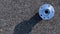 Auto valve. Motor mechanic spare or automotive piece isolated on dark road asphalt background. Black bituminous textured