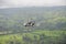 Autogyro flying above the tropical landscape