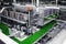 Automated conveyor line in a brewery. Rows of green glass bottles on a conveyor belt. Industrial brewery.