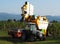 An automated grape harvester machine pours the grapes collected on the trailer of a tractor.
