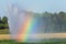 Automated irrigation in agriculture in summer with rainbow