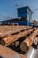 Automated log sorting line. Production of timber from wood. Woodworking. Machining logs. The logs in the sawmill are