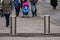 Automatic cylindrical barriers on the pedestrian zone against the background of blurry feet of pedestrians