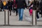 Automatic cylindrical barriers on the pedestrian zone against the background of blurry feet of pedestrians