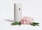 automatic home air freshner next to pink hydrangea flowers on white background. house fragrances and scents for cozy