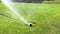 Automatic irrigate sprinkle watering grass at football field