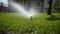 Automatic irrigation system, lawn sprinkler sprayer in action watering grass