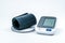 Automatic portable blood pressure machine with arm cuff on white with copy space.