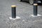 Automatic retractable bollard with glowing lights for control of road traffic and parking