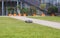 Automatic robot lawnmower mowing green grass on a lawn in a warm sunny summer day