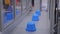 Automatic robotic production line with moving plastic blue pots on conveyor belt