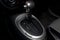 Automatic shift gear knob in the passenger compartment of the car in black for driving and acceleration. Abstract image of fast
