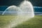 Automatic sprinklers watering grass