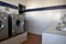 Automatic washing machines and stainless steel sinks iand tabsin a  modern utility room of a campsite