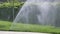 automatic watering grass, garden lawn sprinkler in action.