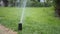 automatic watering grass, garden lawn sprinkler in action.