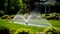 Automatic watering of the green lawn. The nozzle sprays water onto the lawn. Automatic lawn care