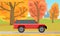 Automobile on background of autumn forest landscape. Red crossover, SUV, cross country car