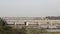 Automobile city traffic on the Signature cable-stayed bridge across the Yamuna River in Delhi against the background of the city