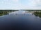 automobile pedestrian bridge across the Luga river in the city of Ust-Luga aerial photo on a summer day