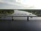 automobile pedestrian bridge across the Luga river in the city of Ust-Luga aerial photo on a summer day