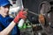 Automobile service. Lubricating car hub while disk and brake pads replacement in repair shop or garage