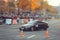 Automobile slalom and drift competitions in the city center, car on the road with cones