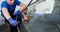 Automobile special workers remove old windscreen of a car in auto service