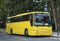 Automotive: Bright yellow private hire coach. 1