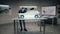 Automotive engineer develops a prototype model car in a modern studio of company