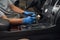 Automotive industry worker carefully detailing car interior