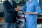 Automotive technician shake hands with customer in front of car in workplace after finish to fix problem