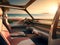 autonomous driving vehicle in at the beach in afternoon light. photorealistic view from inside the vehicle showing a luxurious