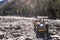 Autonomous dumper Truck Construction vehicle parked on industrial site on bank of Beas River in Manali India with mountain