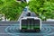 Autonomous electric shuttle bus self driving across city green road, Smart vehicle concept