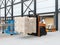 Autonomous forklift carrying pallet of goods in logistics center