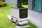 Autonomous parcel delivery robot parked in front of customer house, Smart transportation 5G technology concept