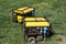 Autonomous portable yellow diesel generator stands on the grass