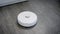 Autonomous robotic vacuum cleaner is moving over floor in home and cleaning surface, turning without human control