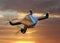 Autonomous unmanned drone with surveillance camera flying in sunset sky