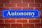 Autonomy street sign on brick wall