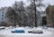 Autos are covered with a snow parked on the street