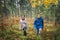 Autumn activity in the forest for healthy life. Children exploring colourful autumn forest