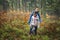 Autumn activity in the forest for healthy life. Children exploring colourful autumn forest