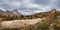 Autumn alpine Dolomites mountain scene, Italy. Dried up Limides Lake near Falzarego Pass