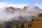 Autumn alpine landscape with colorful larch forest and beautiful mountains in background, Dolomites, Italy, Europe