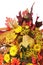 Autumn arrangement of flowers, vegetables and fruits isolated on