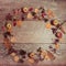 Autumn arrangement of leaves, apples and berries on a wooden background with free space for text. Top view, concept of