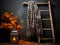 Autumn Ascent: Rustic Wooden Ladder Draped with Plaid Scarves and Amber Leaves on a Slate Gray Canvas