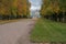 Autumn, autumn forest park autumn trees, yellow forest alley, car, beautiful blue historical architecture, soft daylight,